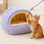 Purple cat cave bed beside an orange cat reaching for a toy